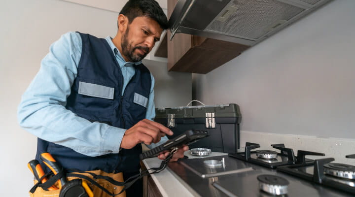 TSSA registered contractor inspecting a gas stove.