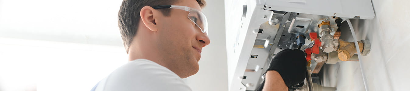 Qualified technician checking a natural gas boiler at home