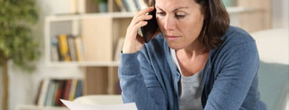 Lady on the phone holding a paper