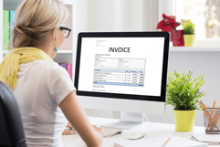 Lady looking at invoice on computer
