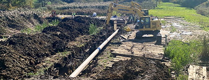 A pipeline and excavator in a construction site