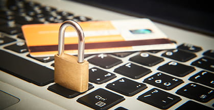 A lock and a credit card placed on the keyboard